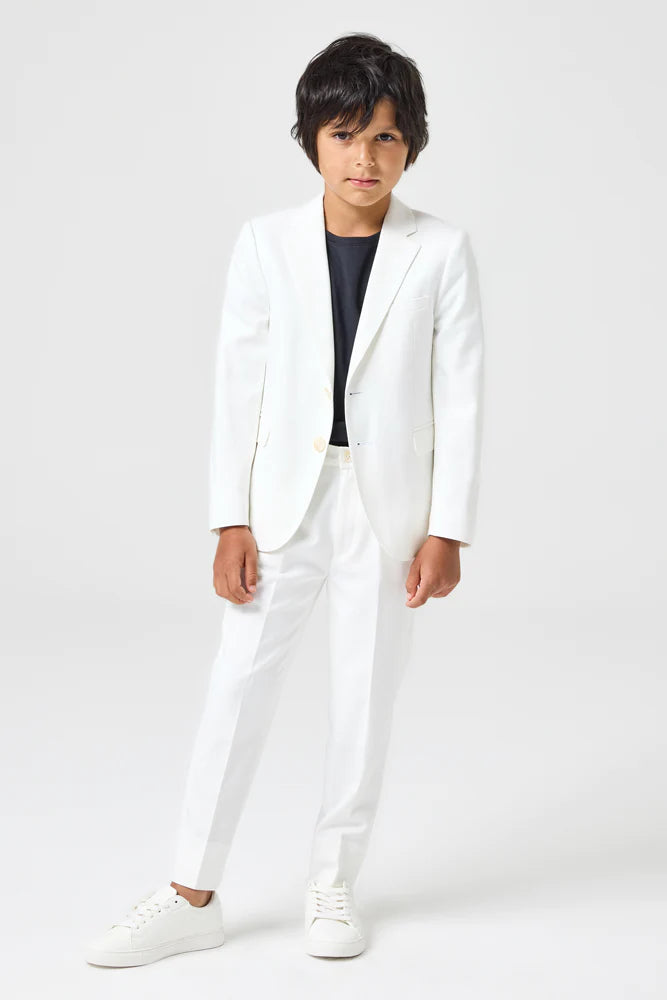 A young boy in a white suit, ready for a wedding
